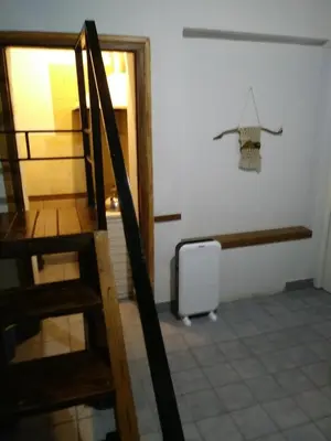 a room with a staircase and a white refrigerator at Alojamiento Libertador in Alta Gracia