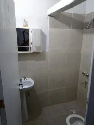 a bathroom with a sink and a toilet at Alojamiento Libertador in Alta Gracia
