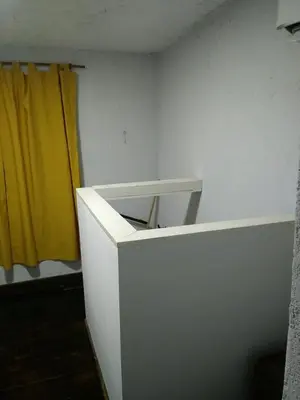 a white desk in a room with a yellow curtain at Alojamiento Libertador in Alta Gracia