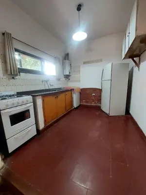 an empty kitchen with a stove and a refrigerator at Casa Centrica Mina Clavero in Mina Clavero