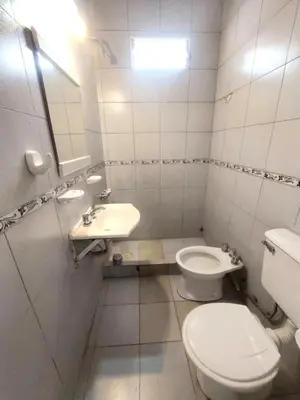 a white bathroom with a toilet and a sink at Casa Centrica Mina Clavero in Mina Clavero