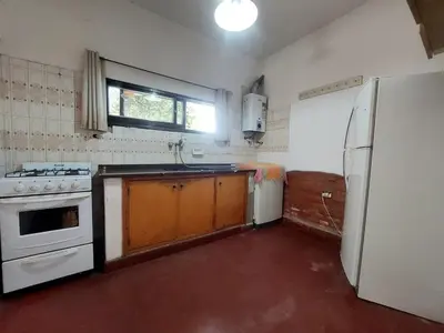 a kitchen with a stove and a refrigerator at Casa Centrica Mina Clavero in Mina Clavero