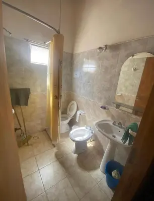 a bathroom with a toilet and a sink at Lo de Alicia 2 in Villa Carlos Paz