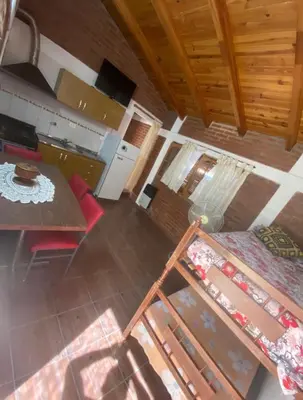 an overhead view of a living room and kitchen with a table at Lo de Alicia 2 in Villa Carlos Paz