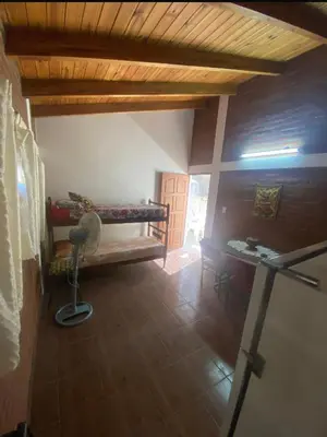 a room with a bed and a desk in a room at Lo de Alicia 2 in Villa Carlos Paz