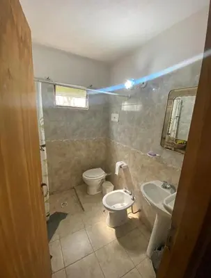 a bathroom with a toilet and a sink at Lo de Alicia 3 in Villa Carlos Paz