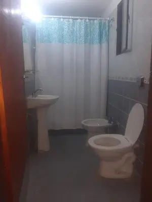 a bathroom with a toilet and a sink at La casa de Milac in Mina Clavero