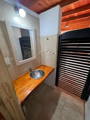 a bathroom with a sink and a mirror at cabaña con pileta in Villa Anizacate