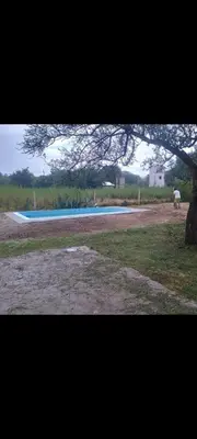 a view of a swimming pool in a field at cabaña con pileta in Villa Anizacate