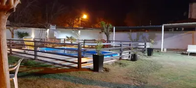 a group of benches with plants in them at night at Arenas Departamentos in Mina Clavero