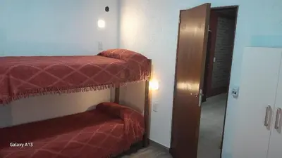 two bunk beds in a room with a mirror at Arenas Departamentos in Mina Clavero