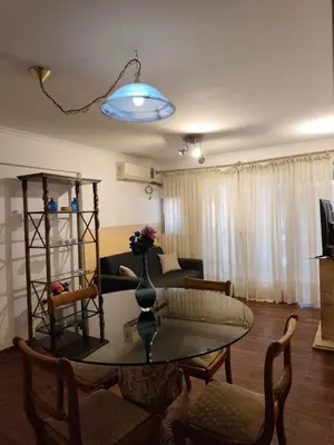 a living room with a table and a couch at Departamento en calle Obispo Trejo in Cordoba