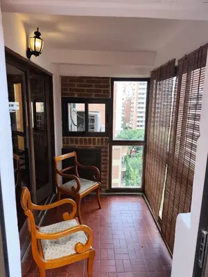 a living room with two chairs and a fireplace at Departamento en calle Obispo Trejo in Cordoba