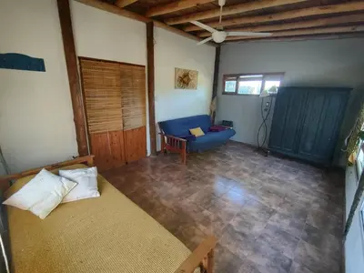 a living room with a blue couch and a chair at Espacio Colibrí in San Francisco del Monte de Oro
