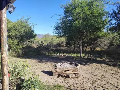 a pile of logs in the middle of a field at Espacio Colibrí in San Francisco del Monte de Oro