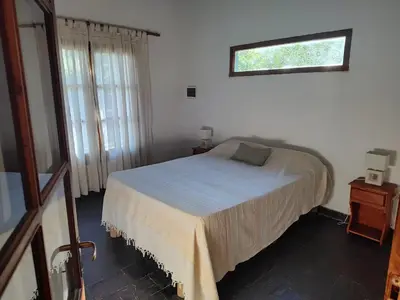 a bedroom with a bed and a window and a window at Espacio Colibrí in San Francisco del Monte de Oro