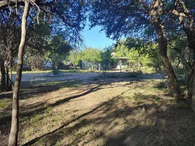 a dirt road with trees in a park at Espacio Colibrí in San Francisco del Monte de Oro