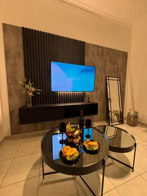 a living room with a table with food and a tv at Calma 1939 in Villa Carlos Paz