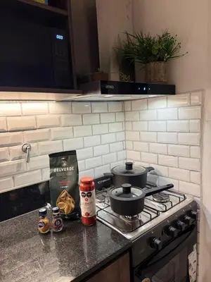 a kitchen with a stove with pots and pans on it at Calma 1939 in Villa Carlos Paz