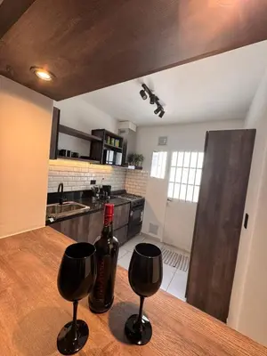 a bottle of wine sitting on a table in a kitchen at Calma 1939 in Villa Carlos Paz