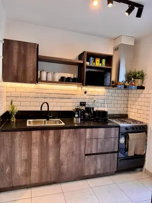 a kitchen with a sink and a stove at Calma 1939 in Villa Carlos Paz