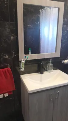 a bathroom with a sink and a mirror at Departamento en Villa del Lago, Carlos Paz in Villa Carlos Paz