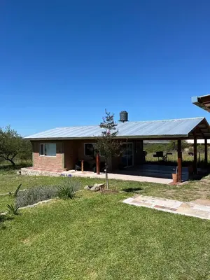 a house with a metal roof and a yard at Terraza de Amancay in Villa Amancay