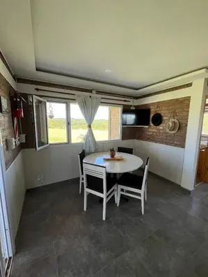 a kitchen and dining room with a table and chairs at Terraza de Amancay in Villa Amancay