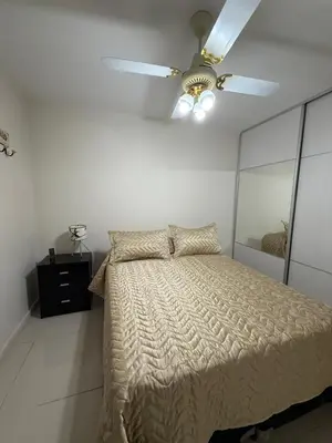 a bedroom with a bed with a ceiling fan at Reggia house in Cordoba