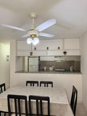 a dining room with a table and a ceiling fan at Reggia house in Cordoba