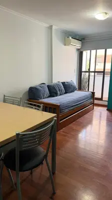 a room with a bed with blue pillows on it at Jacaranda apart in Cordoba