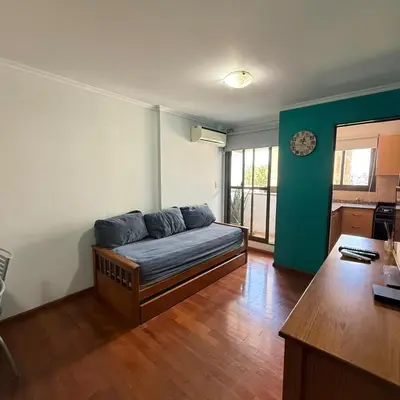 a room with a couch in the middle of a room at Jacaranda apart in Cordoba