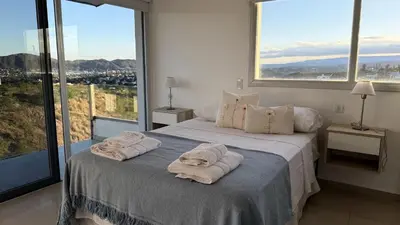 a bedroom with a bed with towels on it at Departamento Carilo Carlos Paz in Villa Carlos Paz