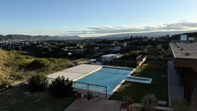 a swimming pool on the side of a house at Departamento Carilo Carlos Paz in Villa Carlos Paz