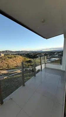a large white room with a view of a city at Departamento Carilo Carlos Paz in Villa Carlos Paz