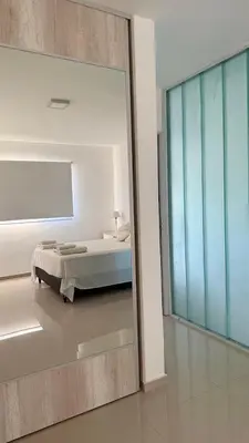 a bedroom with a bed and a large mirror at Departamento Carilo Carlos Paz in Villa Carlos Paz