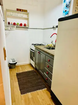 a kitchen with a sink and a stove at Encantador departamento en Güemes in Cordoba
