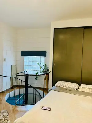 a room with a bed and a glass table at Encantador departamento en Güemes in Cordoba