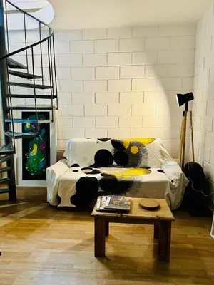 a room with a bed and a coffee table with a table at Encantador departamento en Güemes in Cordoba