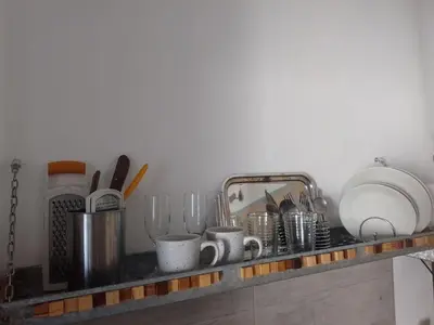 a kitchen counter with dishes and utensils on it at Estudio en Nueva Córdoba in Cordoba