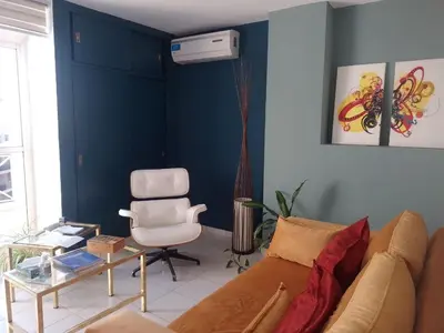 a living room with a couch and a chair at Estudio en Nueva Córdoba in Cordoba