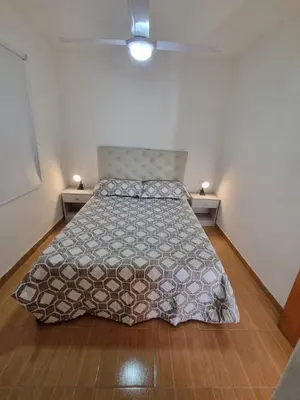 a bed in a small room with two night stands at Casa de Tanti in Tanti