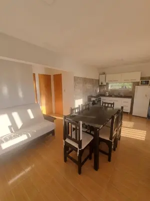 a room with a table and chairs and a kitchen at Casa de Tanti in Tanti