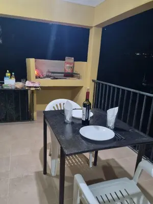 a black table with a bottle of wine and chairs at Casa de Tanti in Tanti