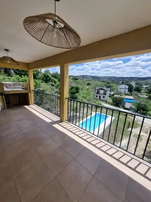a balcony with a view of a swimming pool at Casa de Tanti in Tanti