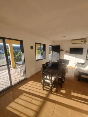 a living room with a pool table and a deck at Casa de Tanti in Tanti