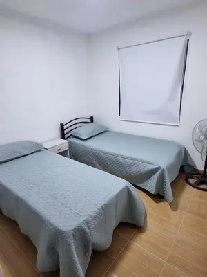 a bedroom with two beds and a lamp in it at Casa de Tanti in Tanti