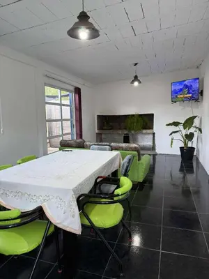 a conference room with a table and green chairs at Depto Santa Cruz in Villa Santa Cruz del Lago