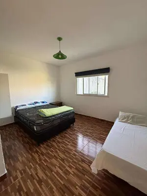 a room with two beds and a couch in it at Depto Santa Cruz in Villa Santa Cruz del Lago