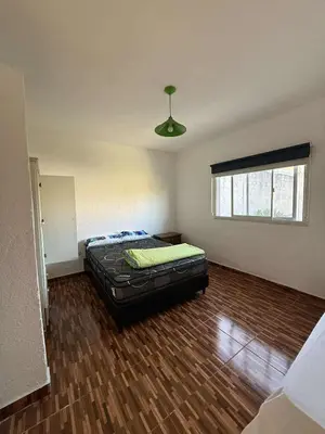 a bedroom with a bed in the middle of a room at Depto Santa Cruz in Villa Santa Cruz del Lago